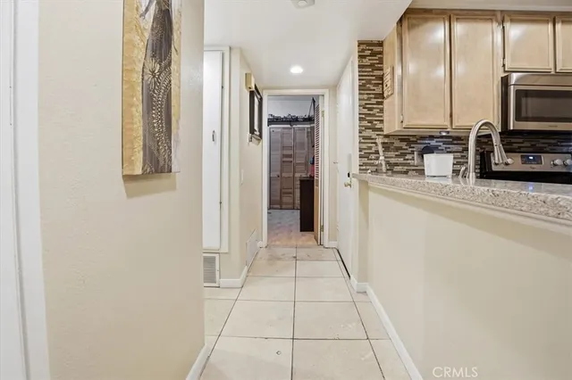 a view of a kitchen with a refrigerator and a sink
