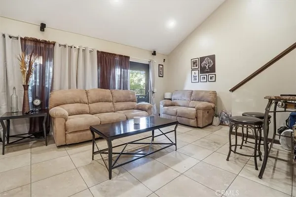 a kitchen with stainless steel appliances granite countertop furniture a refrigerator a sink and white cabinets