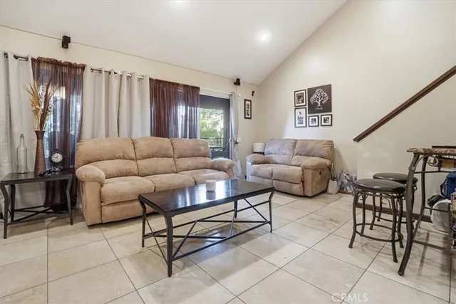 a kitchen with stainless steel appliances granite countertop furniture a refrigerator a sink and white cabinets