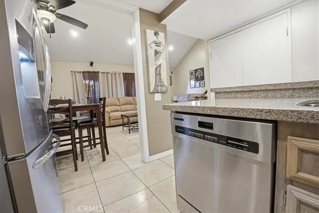 a kitchen with kitchen island a counter top space cabinets and stainless steel appliances
