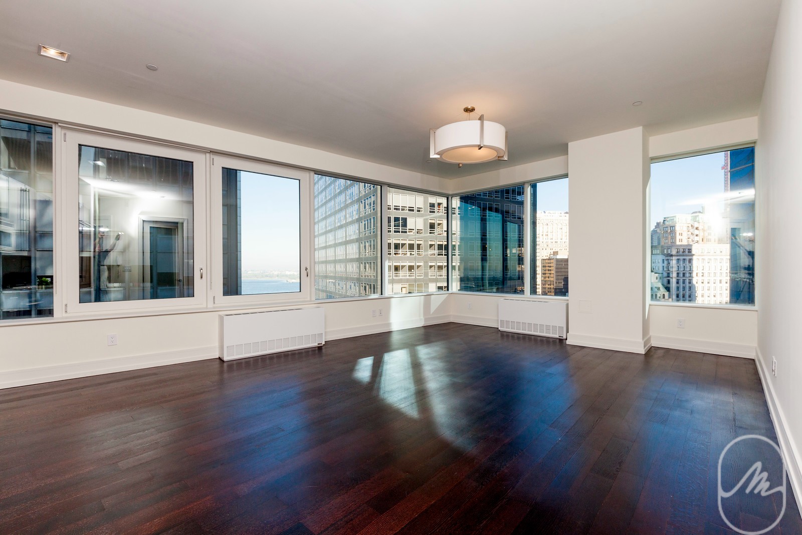 2 Water Street, Unit PHC Manhattan, NY 10004 - Photo 1 of 20 an empty room with wooden floor and windows