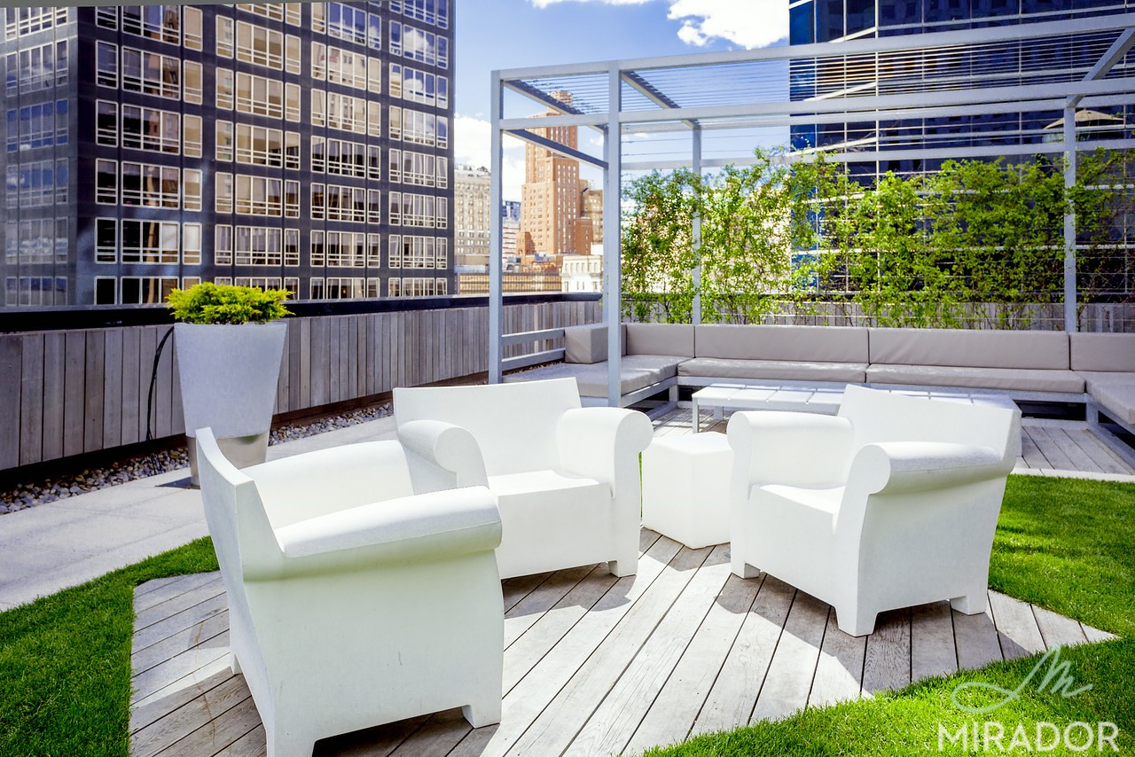 2 Water Street, Unit PHC Manhattan, NY 10004 - Photo 15 of 20 a view of a patio with couches and a potted plant on a table