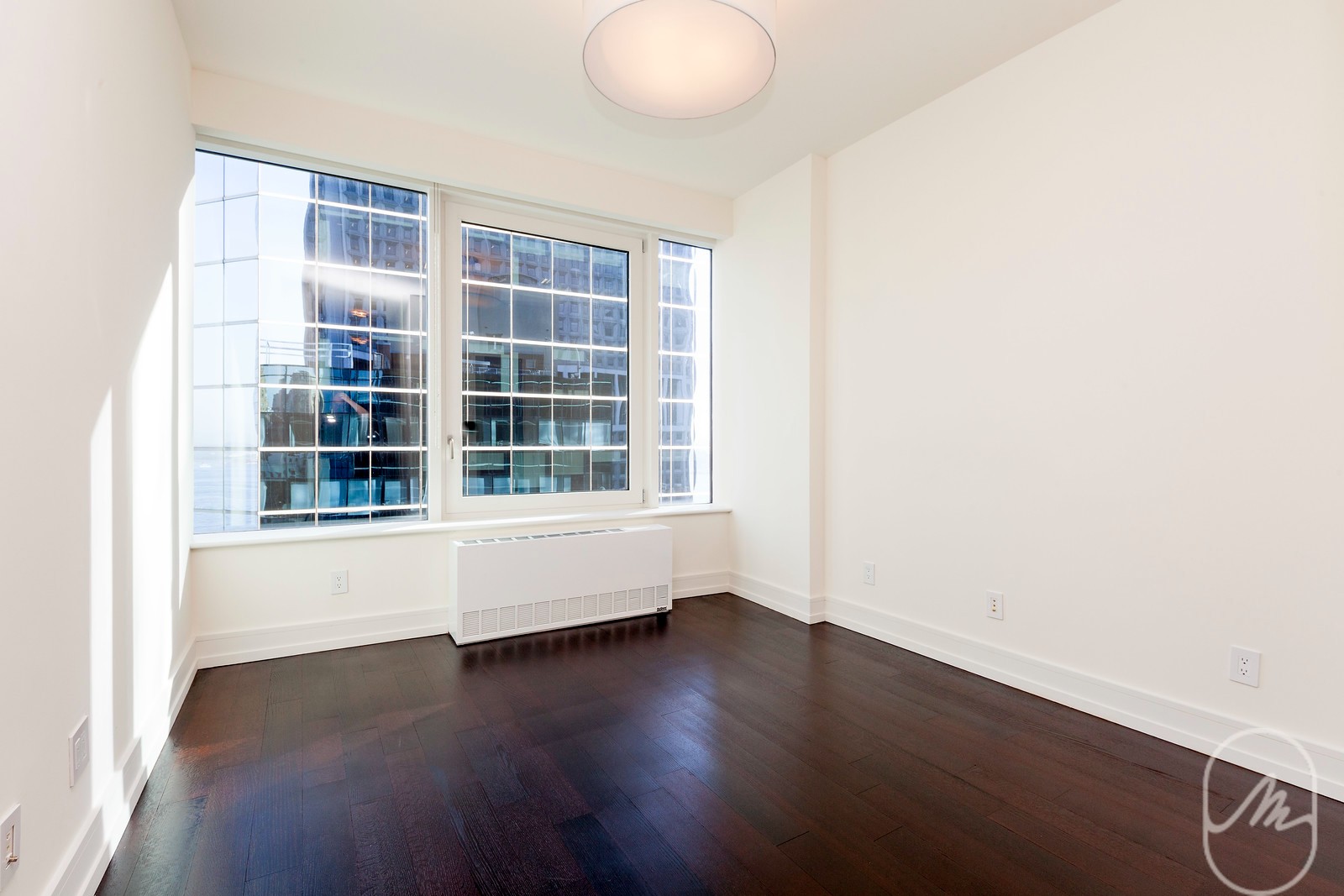 2 Water Street, Unit PHC Manhattan, NY 10004 - Photo 4 of 20 an empty room with wooden floor and windows