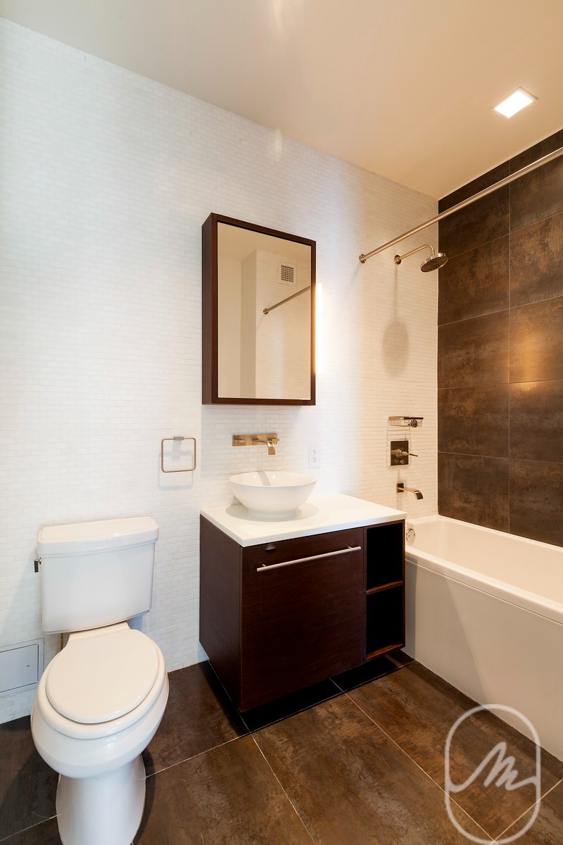 2 Water Street, Unit PHC Manhattan, NY 10004 - Photo 9 of 20 a bathroom with a sink toilet and bathtub