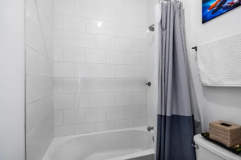 a bathroom with a tub and shower