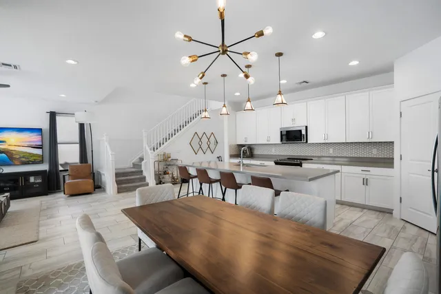 a living room with lots of furniture and kitchen view