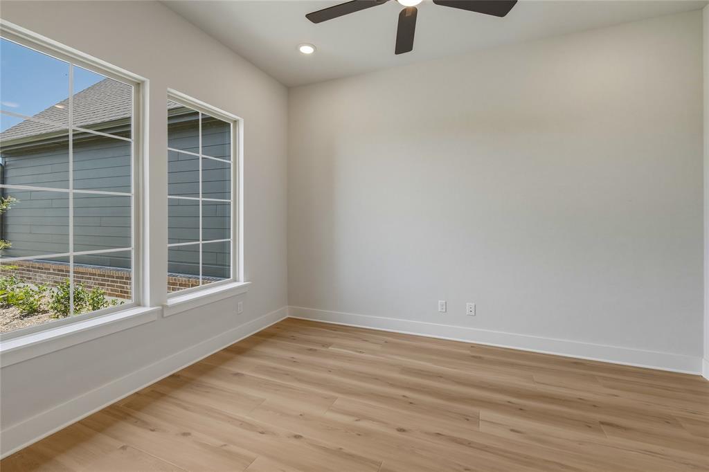 2305 Gypsum Street Krum, TX 76249 - Photo 10 of 26 Room with wood-finish flooring, two large windows with grid patterns, a ceiling fan, and recessed lighting
