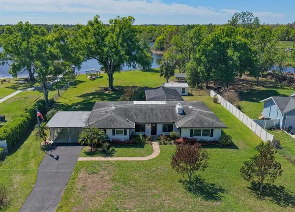 an aerial view of a house with swimming pool garden and patio