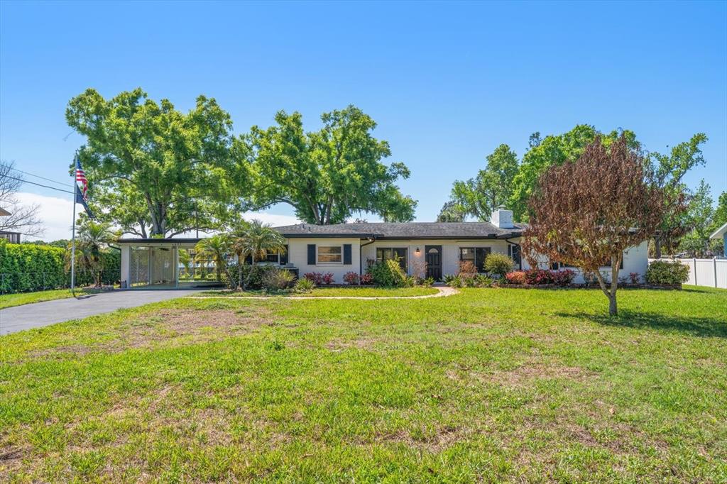 421 East County Line Road Lutz, FL 33549 - Photo 21 of 37 a front view of a house with garden