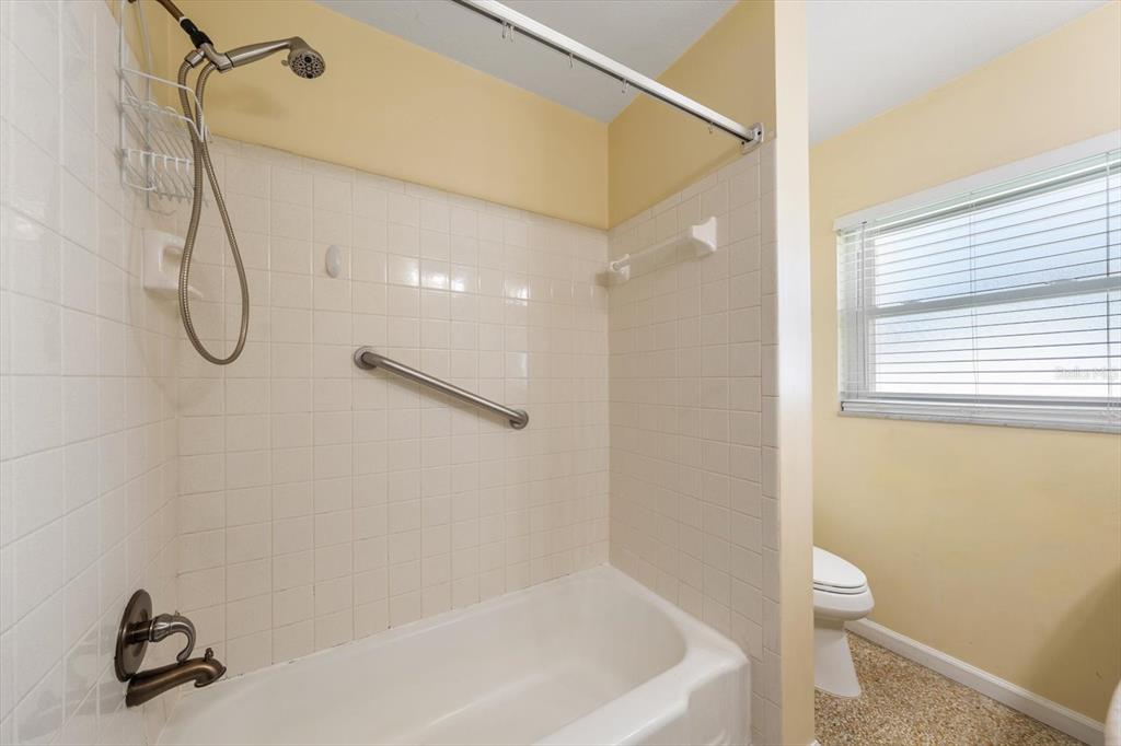 421 East County Line Road Lutz, FL 33549 - Photo 28 of 37 a bathroom with a shower and a ceiling fan