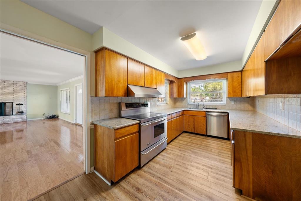 421 East County Line Road Lutz, FL 33549 - Photo 9 of 37 a kitchen with stove cabinets and wooden floor