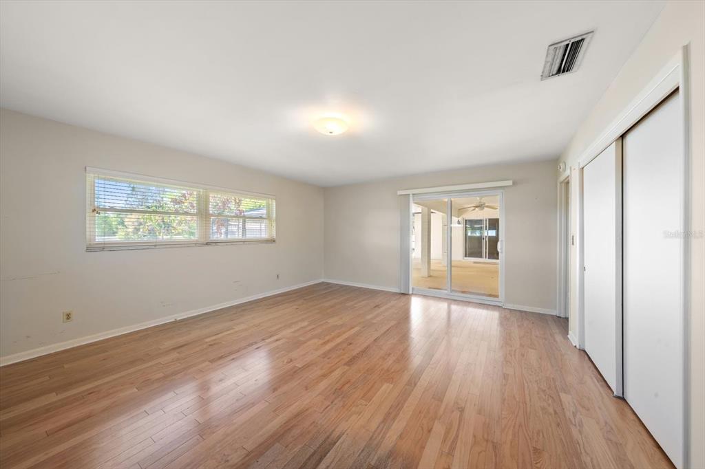 421 East County Line Road Lutz, FL 33549 - Photo 10 of 37 a view of an empty room with wooden floor and a window