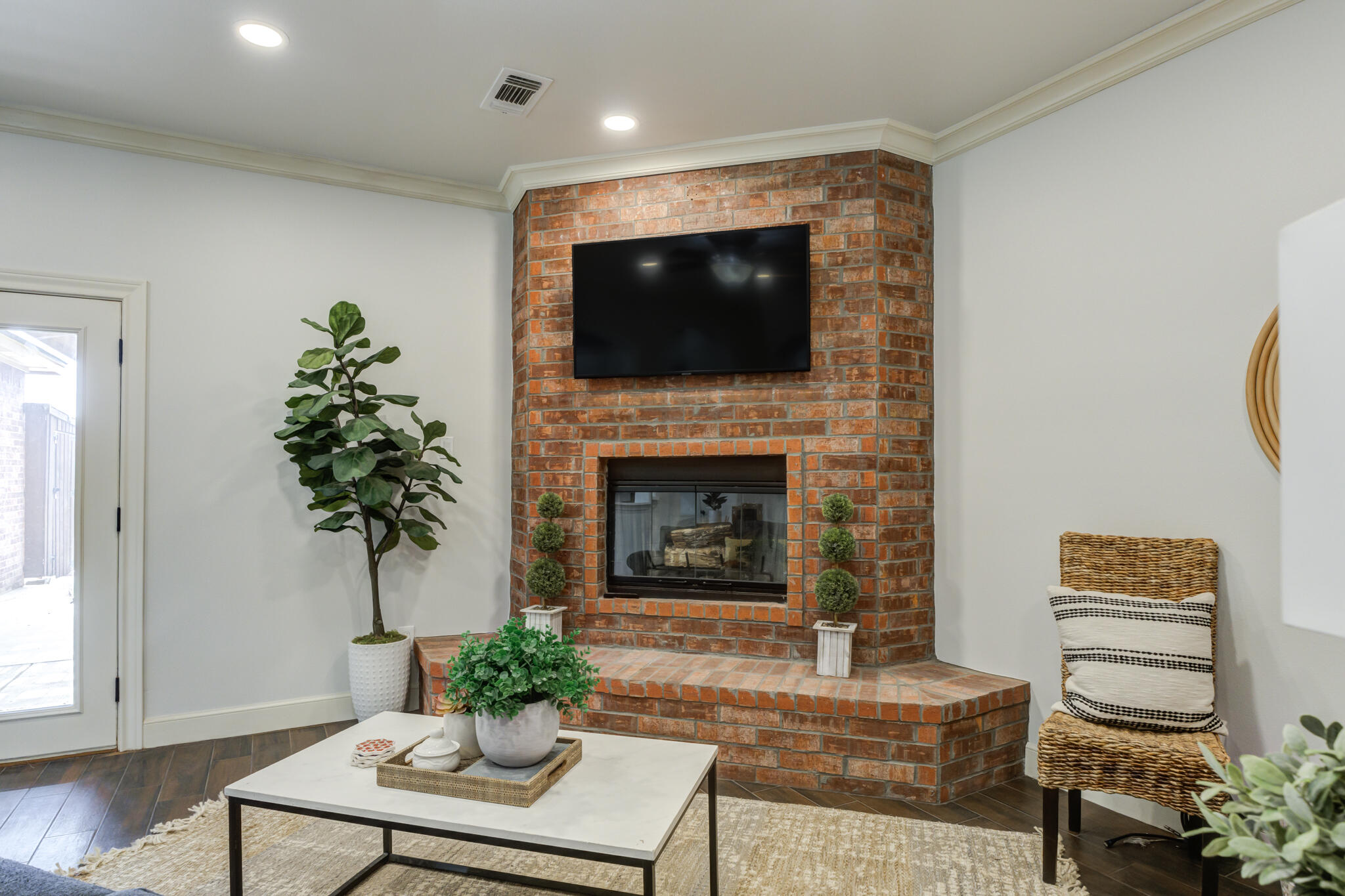 11110 Detroit Avenue Lubbock, TX 79423 - Photo 14 of 54 a living room with furniture a flat screen tv and a fireplace
