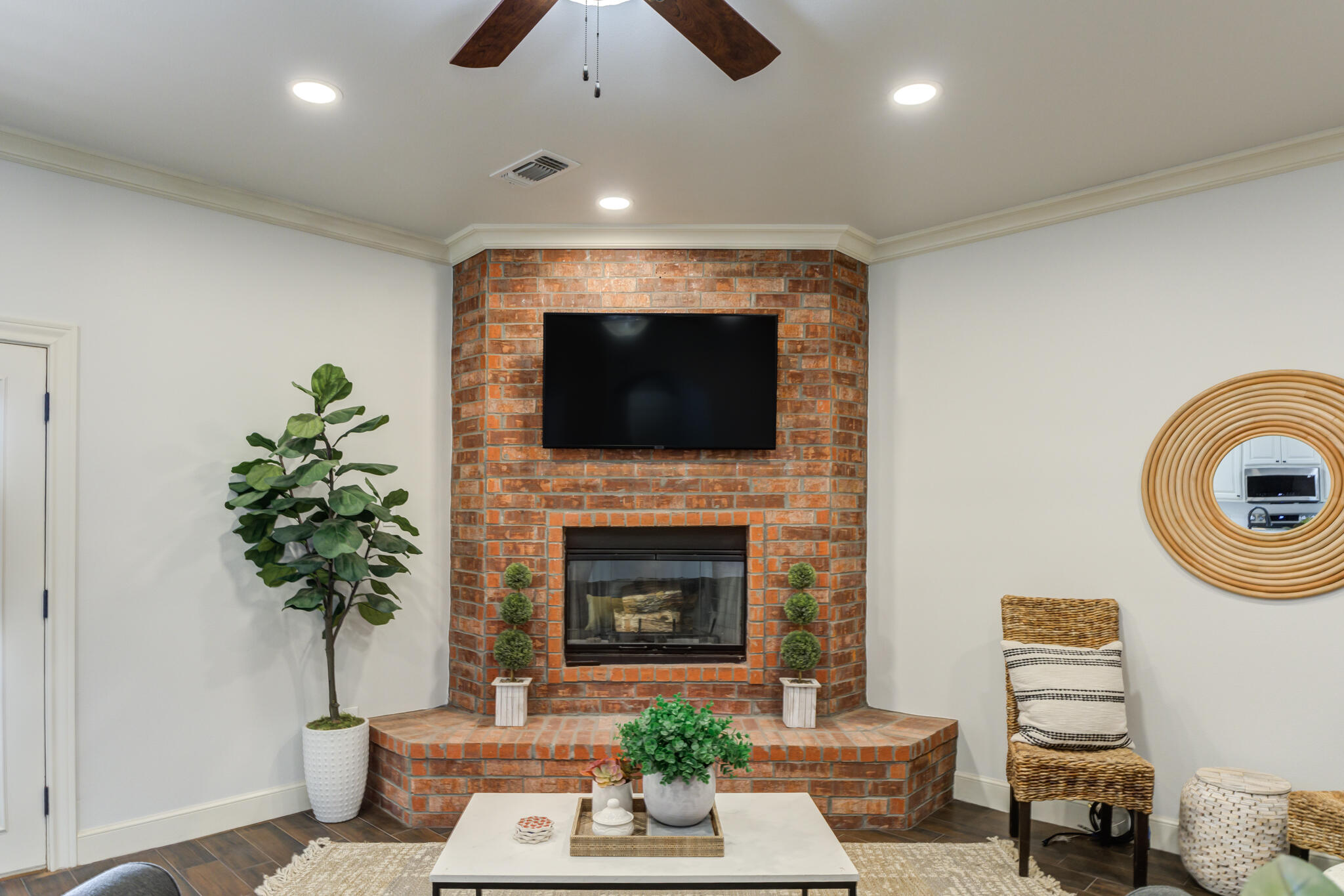 11110 Detroit Avenue Lubbock, TX 79423 - Photo 15 of 54 a living room with furniture a potted plant and a fireplace