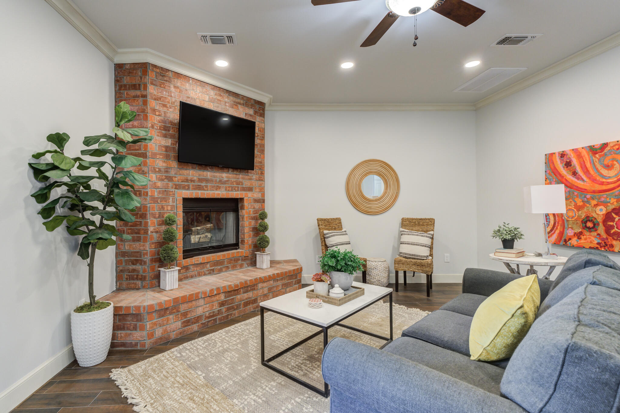 11110 Detroit Avenue Lubbock, TX 79423 - Photo 16 of 54 a living room with furniture a fireplace and a flat screen tv