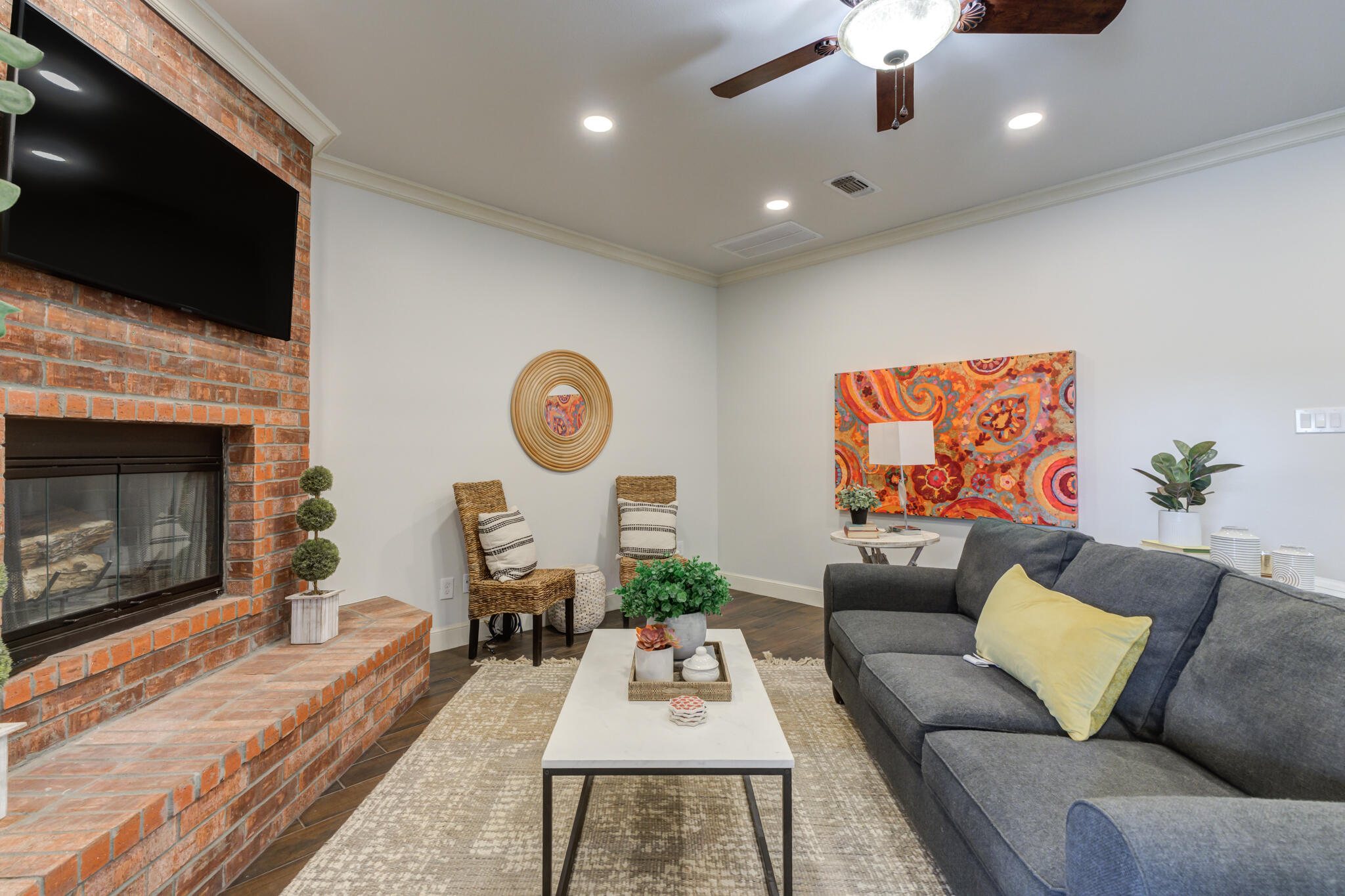 11110 Detroit Avenue Lubbock, TX 79423 - Photo 17 of 54 a living room with furniture a flat screen tv and a fireplace