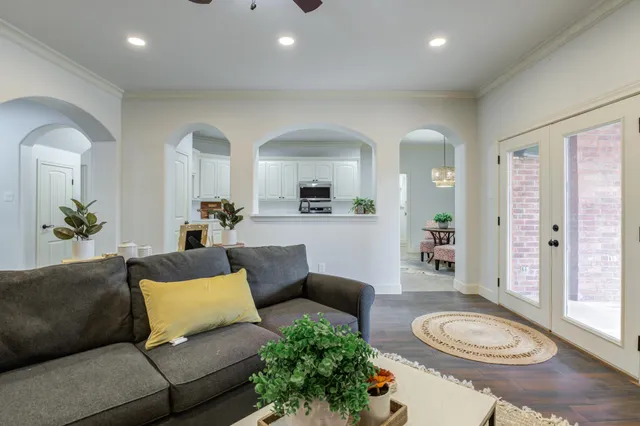 an empty room with wooden floor and a sink