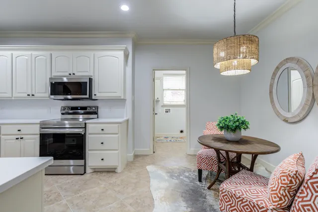a kitchen with white cabinets and stainless steel appliances