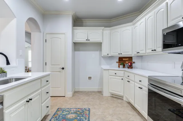 a kitchen with stainless steel appliances a sink and cabinets