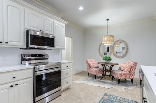 a living room with furniture a flat screen tv and a window