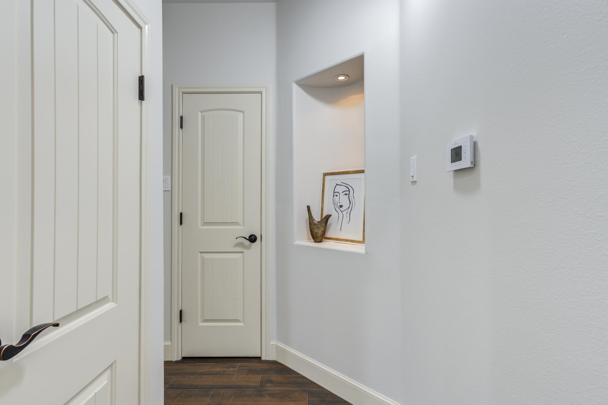 11110 Detroit Avenue Lubbock, TX 79423 - Photo 30 of 54 a view of a hallway with wooden floor