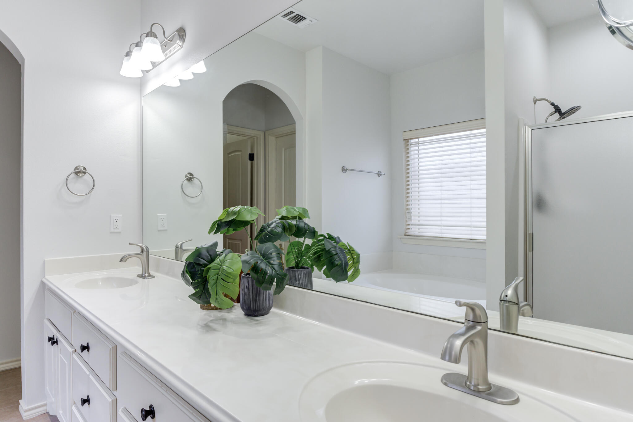 11110 Detroit Avenue Lubbock, TX 79423 - Photo 36 of 54 a bathroom with a sink a vanity and a mirror