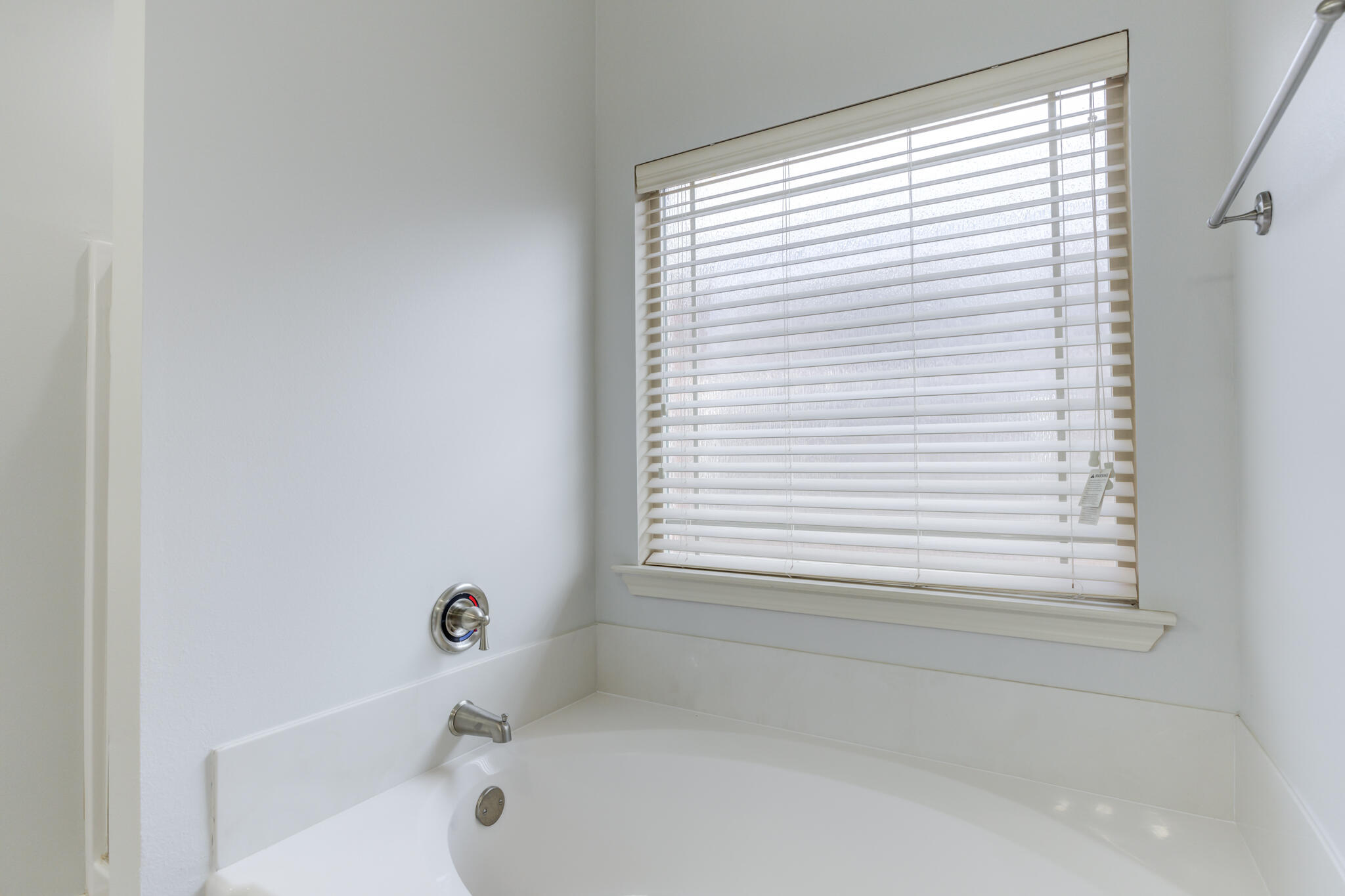 11110 Detroit Avenue Lubbock, TX 79423 - Photo 38 of 54 a bathroom with a bathtub next to a window