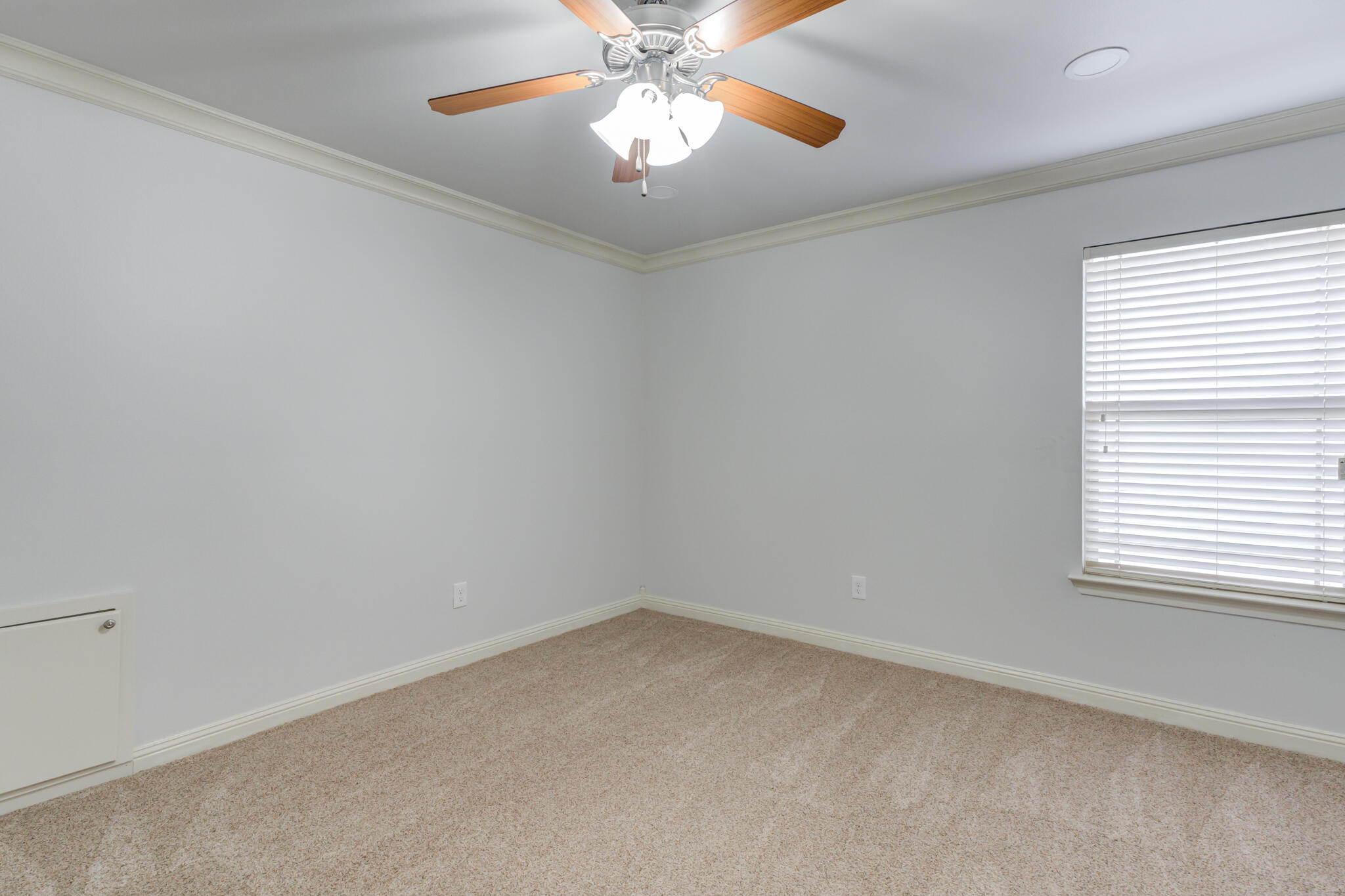 11110 Detroit Avenue Lubbock, TX 79423 - Photo 40 of 54 an empty room with a window and a chandelier fan