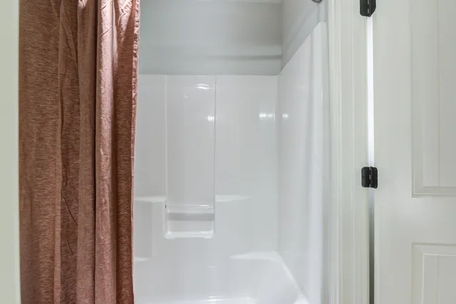 a bathroom with a sink and mirror with window