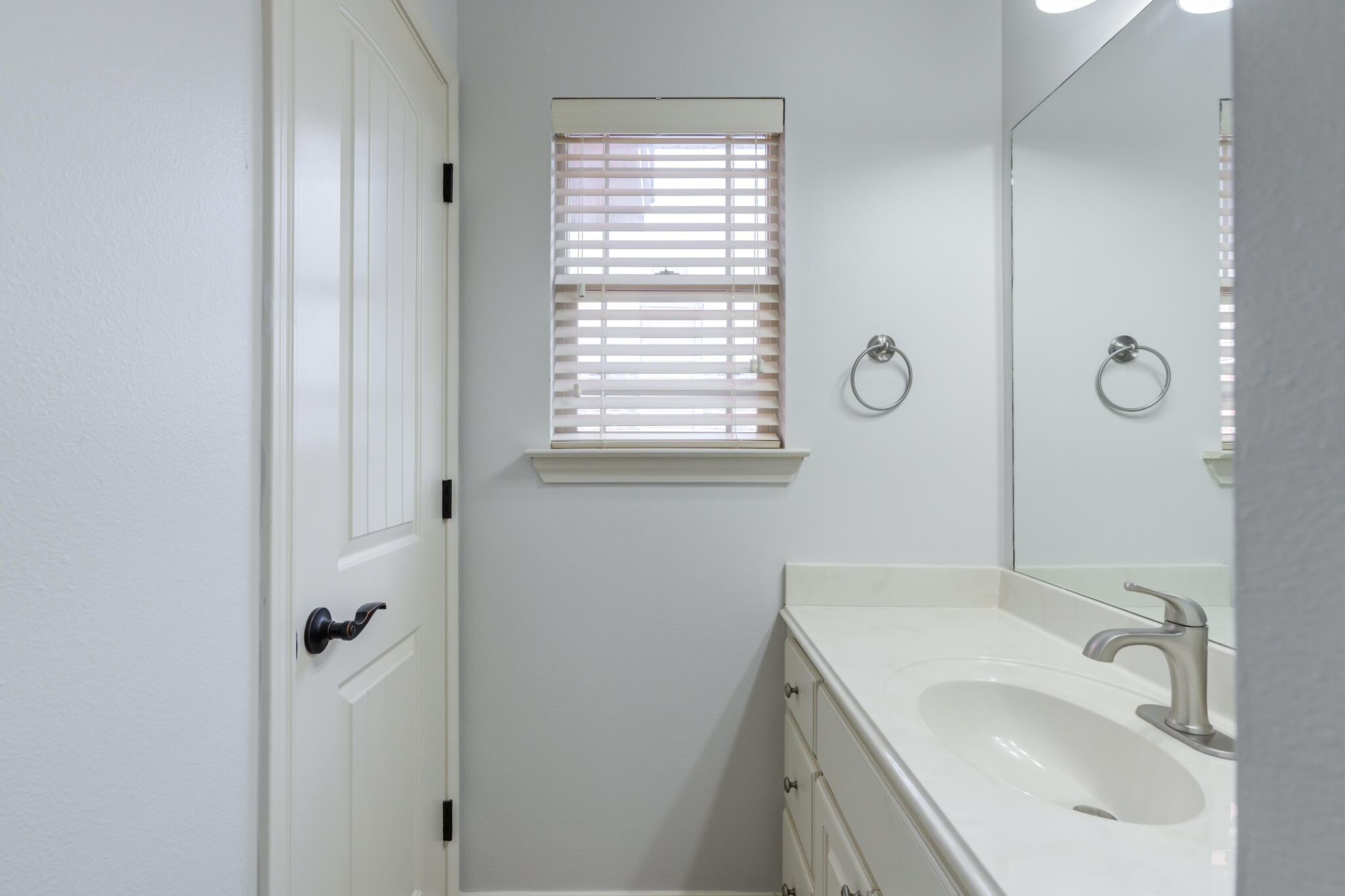 11110 Detroit Avenue Lubbock, TX 79423 - Photo 45 of 54 a bathroom with a sink and mirror with window