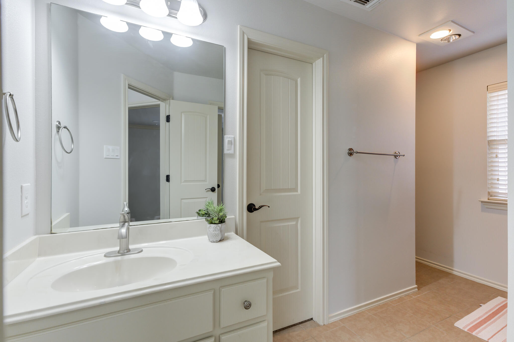 11110 Detroit Avenue Lubbock, TX 79423 - Photo 50 of 54 a bathroom with a sink and a mirror