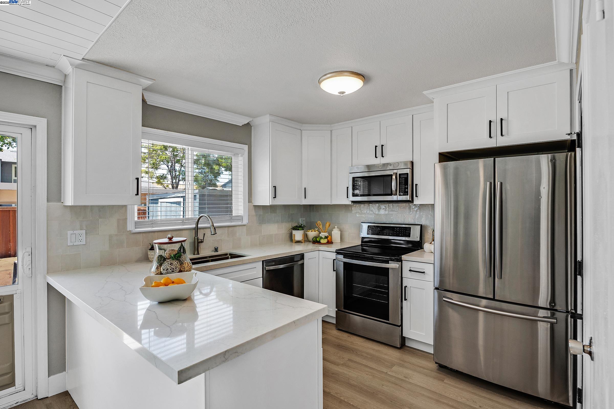 1323 Spring Valley Common Livermore, CA 94551 - Photo 1 of 1 a kitchen with stainless steel appliances a refrigerator stove and sink