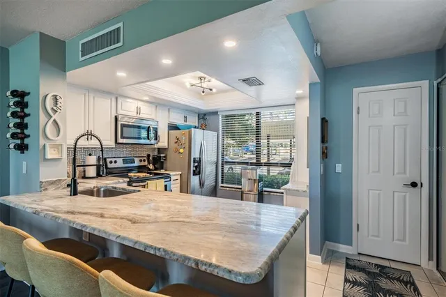 a kitchen with stainless steel appliances granite countertop a sink and stove