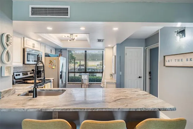 a outdoor space with granite countertop a couch and chandelier