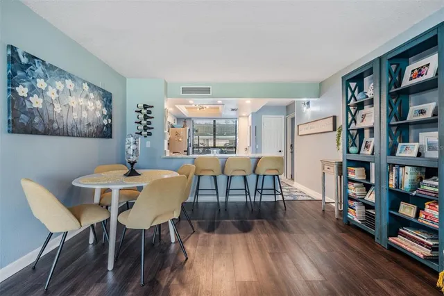 a view of a dining room with furniture and a book shelf