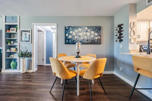 a dining room with furniture and wooden floor