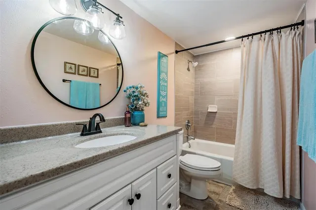 a bathroom with a toilet a sink and a mirror