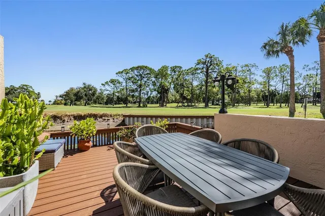 a view of a chairs and table on the deck
