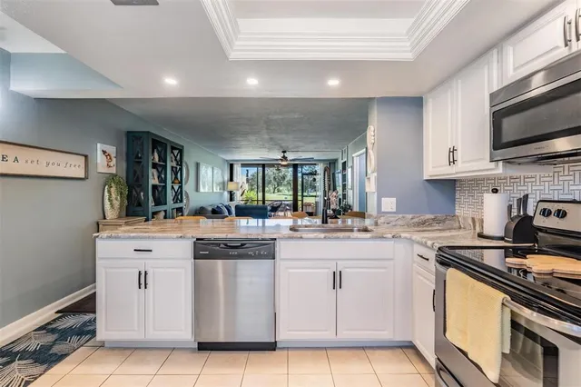 a kitchen with cabinets appliances and a sink