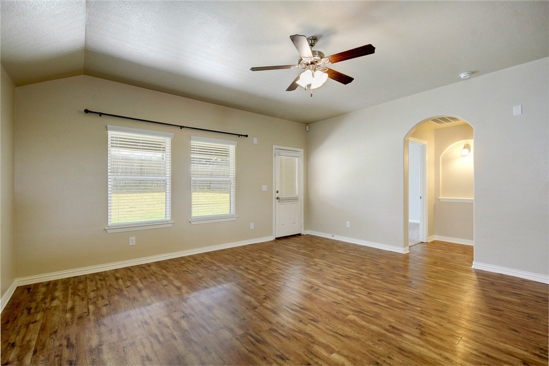 3621 Rams Horn Way Round Rock, TX 78665 - Photo 6 of 24 a view of an empty room with window and wooden floor
