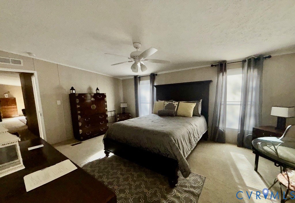 1585 Ullainee Road Caret, VA 22436 - Photo 5 of 10 a bedroom with a bed and a chandelier