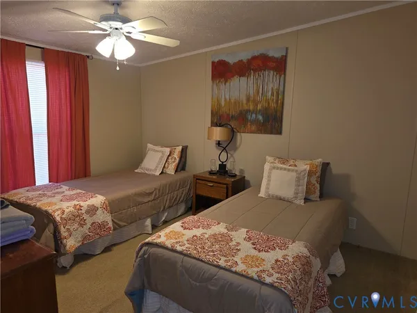 a bedroom with two beds and a chandelier