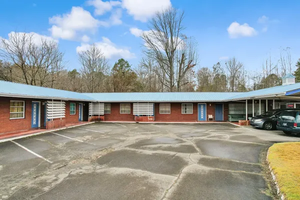 a front view of house with yard and trees around