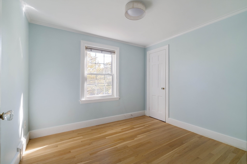 143 South Street Brookline, MA 02467 - Photo 24 of 32 a view of an empty room with wooden floor and a window
