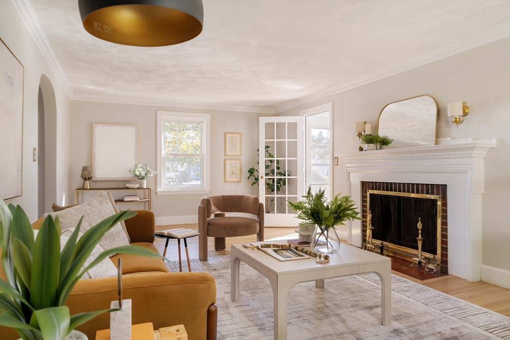 143 South Street Brookline, MA 02467 - Photo 3 of 32 a living room with furniture a potted plant and a fireplace