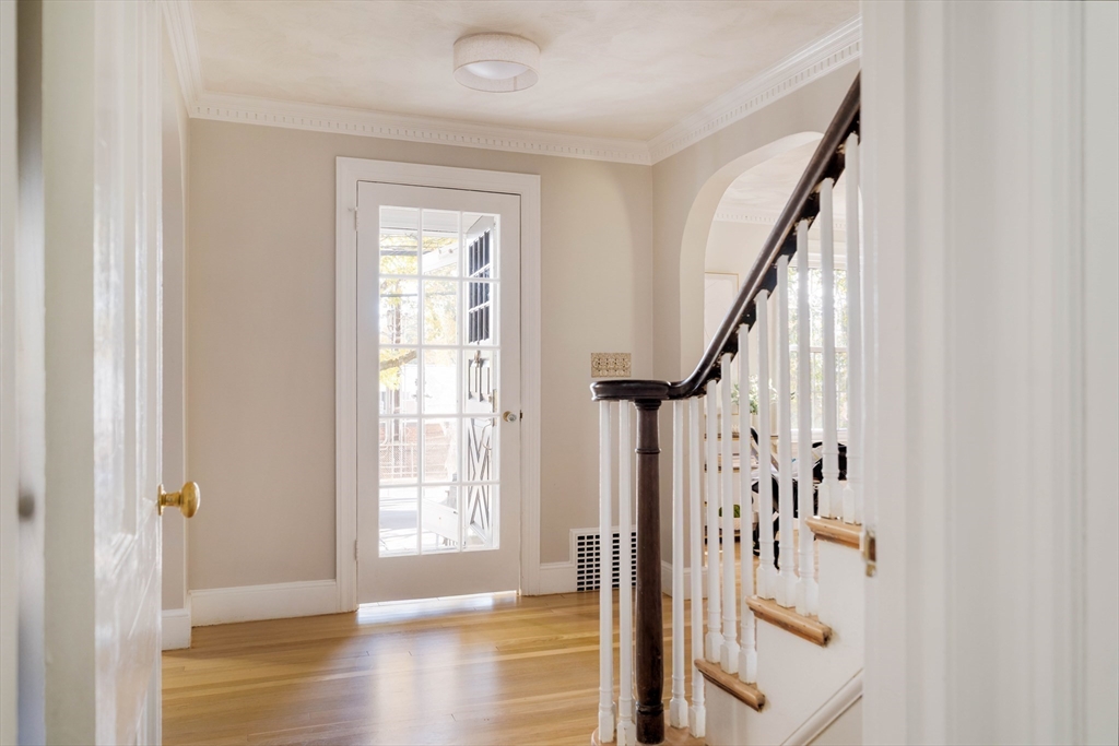 143 South Street Brookline, MA 02467 - Photo 7 of 32 a view of entryway with wooden floor and stairs