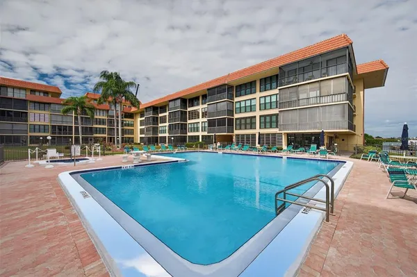 a view of a swimming pool with a lounge chairs