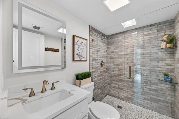 a bathroom with a sink toilet and shower