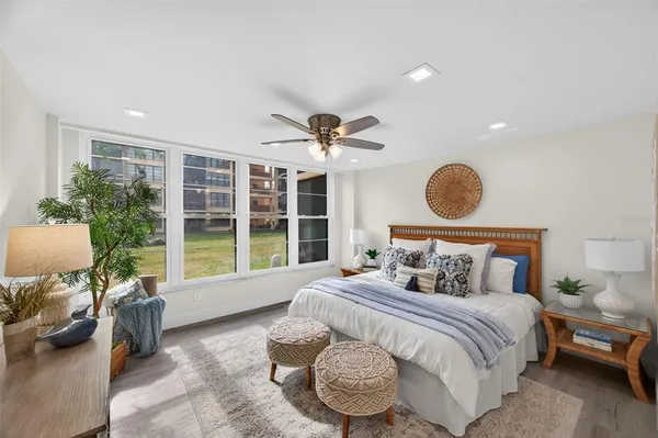 a bedroom with a bed gym equipment and a large window