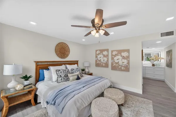 a bedroom with a large bed and a chandelier